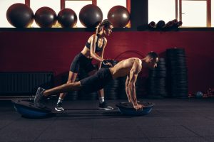 man and woman doing bodybuilding and weight training